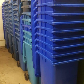 Stacked blue wheelie bins