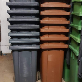 Stacked brown, black and green wheelie bins