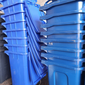 Stacks of blue wheelie bins